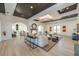 Bright living room featuring a fireplace, a large chandelier, and light tile flooring at 4987 Kyle Dr, Powder Springs, GA 30127