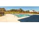 Community pool and concrete deck with neighborhood residences and green spaces in the background on a sunny day at 4987 Kyle Dr, Powder Springs, GA 30127