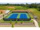 Aerial view of tennis courts, surrounded by landscaping, fencing, and parking at 4987 Kyle Dr, Powder Springs, GA 30127