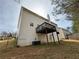 Back exterior view of home featuring a wooden deck and a small yard in need of some maintenance at 675 Paper Creek Dr, Lawrenceville, GA 30046