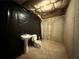 Unfinished basement bathroom space with a sink and toilet next to a wall covered in a black plastic sheet at 675 Paper Creek Dr, Lawrenceville, GA 30046