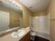 This bathroom is well-lit and clean, with a tub-shower, wooden vanity, and tile floors at 675 Paper Creek Dr, Lawrenceville, GA 30046