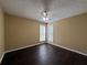 Bright bedroom featuring dark floors and light-colored walls, with two windows providing ample natural light at 675 Paper Creek Dr, Lawrenceville, GA 30046