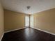 Bright bedroom featuring dark floors and light-colored walls, with two windows providing ample natural light at 675 Paper Creek Dr, Lawrenceville, GA 30046