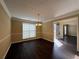 Dining room featuring dark floors, decorative lighting fixture, and adjacent rooms at 675 Paper Creek Dr, Lawrenceville, GA 30046