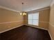 Dining room featuring dark floors, and decorative lighting fixture at 675 Paper Creek Dr, Lawrenceville, GA 30046