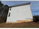 Side of home with white vinyl siding and landscaping needing attention in yard at 675 Paper Creek Dr, Lawrenceville, GA 30046