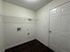 This laundry room is ready for your washer and dryer, featuring tile floors and a wire shelf at 675 Paper Creek Dr, Lawrenceville, GA 30046