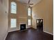 Open-concept living room featuring a fireplace and tall ceilings at 675 Paper Creek Dr, Lawrenceville, GA 30046