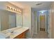 Bright bathroom featuring a vanity with a large mirror and access to a walk-in closet at 1109 Willow Crest Way, Austell, GA 30168