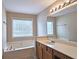 Bathroom featuring a soaking tub, window, and vanity with ample counter space at 1109 Willow Crest Way, Austell, GA 30168