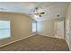 Large carpeted bedroom featuring a ceiling fan and windows that provide ample natural light at 1109 Willow Crest Way, Austell, GA 30168