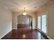 Dining area with hardwood floors, French doors to the backyard, and stylish lighting fixture at 1109 Willow Crest Way, Austell, GA 30168