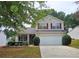 Charming two-story home with a well-maintained front yard and attached two car garage at 1109 Willow Crest Way, Austell, GA 30168