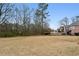 Expansive backyard with room for outdoor activities, featuring an in-ground pool and mature trees at 3023 Lawson Dr, Marietta, GA 30064