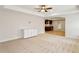 Finished basement space with neutral walls, plush carpeting, and a kitchenette with stainless steel appliances at 3023 Lawson Dr, Marietta, GA 30064