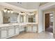 Bright bathroom with dual vanities, white cabinets, and stylish lighting fixtures create a spa-like feel at 3023 Lawson Dr, Marietta, GA 30064