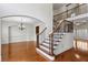 Spacious foyer with hardwood floors, staircase, archways, and a decorative chandelier at 3023 Lawson Dr, Marietta, GA 30064