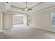 Spacious main bedroom with trey ceiling, plantation shutters, and neutral carpeting at 3023 Lawson Dr, Marietta, GA 30064