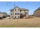 Rear exterior view of home with a deck, traditional architecture, and a well-maintained lawn at 3023 Lawson Dr, Marietta, GA 30064