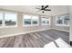 Bright and airy bedroom featuring multiple windows, neutral walls, and wood-look floors at 3241 Broadnax Mill Rd, Loganville, GA 30052