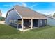 Spacious backyard featuring a covered patio with outdoor furniture and lush lawn at 53 Colonial Ter, Villa Rica, GA 30180