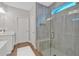 Modern bathroom featuring a glass-enclosed shower with gray tile and a built-in seat, plus dual sinks at 53 Colonial Ter, Villa Rica, GA 30180