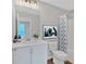 Bright bathroom with stylish decor, vanity and shower/tub with patterned curtain at 53 Colonial Ter, Villa Rica, GA 30180