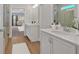 Well-lit bathroom featuring double sinks, walk-in shower, and wood-look flooring at 53 Colonial Ter, Villa Rica, GA 30180