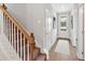 Inviting home entryway featuring a carpeted staircase and access to a sunlit front door at 53 Colonial Ter, Villa Rica, GA 30180