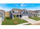 A view of a blue home's exterior showcasing the clean lines, manicured lawn, and welcoming curb appeal at 53 Colonial Ter, Villa Rica, GA 30180
