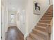 Hallway with hardwood floors, stairway to second floor and front door entrance at 53 Colonial Ter, Villa Rica, GA 30180
