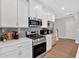 Gourmet kitchen featuring stainless steel appliances, quartz countertops, and ample cabinet space at 53 Colonial Ter, Villa Rica, GA 30180
