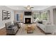 Open concept living room with fireplace, contemporary decor, and large windows offering scenic views at 53 Colonial Ter, Villa Rica, GA 30180