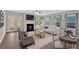 Inviting living room featuring a cozy fireplace, lots of natural light, and stylish furnishings at 53 Colonial Ter, Villa Rica, GA 30180
