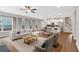 Open living space with hardwood floors, lots of light, and a modern kitchen in the background at 53 Colonial Ter, Villa Rica, GA 30180