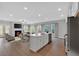 Open-concept living area with a fireplace, dining space, and a kitchen island at 53 Colonial Ter, Villa Rica, GA 30180