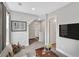 Comfortable living room area with a sofa, television, and adjacent hallway at 53 Colonial Ter, Villa Rica, GA 30180