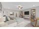 Spacious main bedroom features neutral tones, decor shelving, a ceiling fan, and a large window at 53 Colonial Ter, Villa Rica, GA 30180
