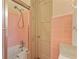 This bathroom has a bathtub with glass shower door and pink tiles at 643 Longstreet Dr, Marietta, GA 30064