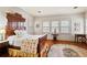 This bedroom features a large carved wood bed frame, hardwood flooring, and plenty of natural light from the windows at 643 Longstreet Dr, Marietta, GA 30064