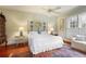 Bright bedroom with natural light, hardwood floors, ceiling fan, and a cozy sitting area at 643 Longstreet Dr, Marietta, GA 30064