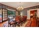 Formal dining room showcasing chandelier, access to backyard, and decorative wallpaper design at 643 Longstreet Dr, Marietta, GA 30064