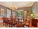 Elegant dining room with stylish wallpaper, beautiful chandelier, and French doors leading to the backyard at 643 Longstreet Dr, Marietta, GA 30064