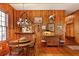 Warm dining room featuring wood paneling, chandelier, beautiful hardwood floors, and classic styling at 643 Longstreet Dr, Marietta, GA 30064
