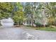 Exterior view of the home with a detached garage, mature trees, and a circular driveway at 643 Longstreet Dr, Marietta, GA 30064