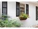 Charming white brick home with black shutters and a window box full of vibrant red flowers at 643 Longstreet Dr, Marietta, GA 30064