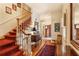 Elegant foyer with hardwood floors, a staircase with a red runner, and antique furniture at 643 Longstreet Dr, Marietta, GA 30064