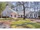 Charming white brick home featuring a brick driveway, covered porch, and beautifully landscaped front yard at 643 Longstreet Dr, Marietta, GA 30064
