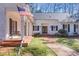 Inviting covered front porch with columns, brick flooring, and a charming porch swing at 643 Longstreet Dr, Marietta, GA 30064